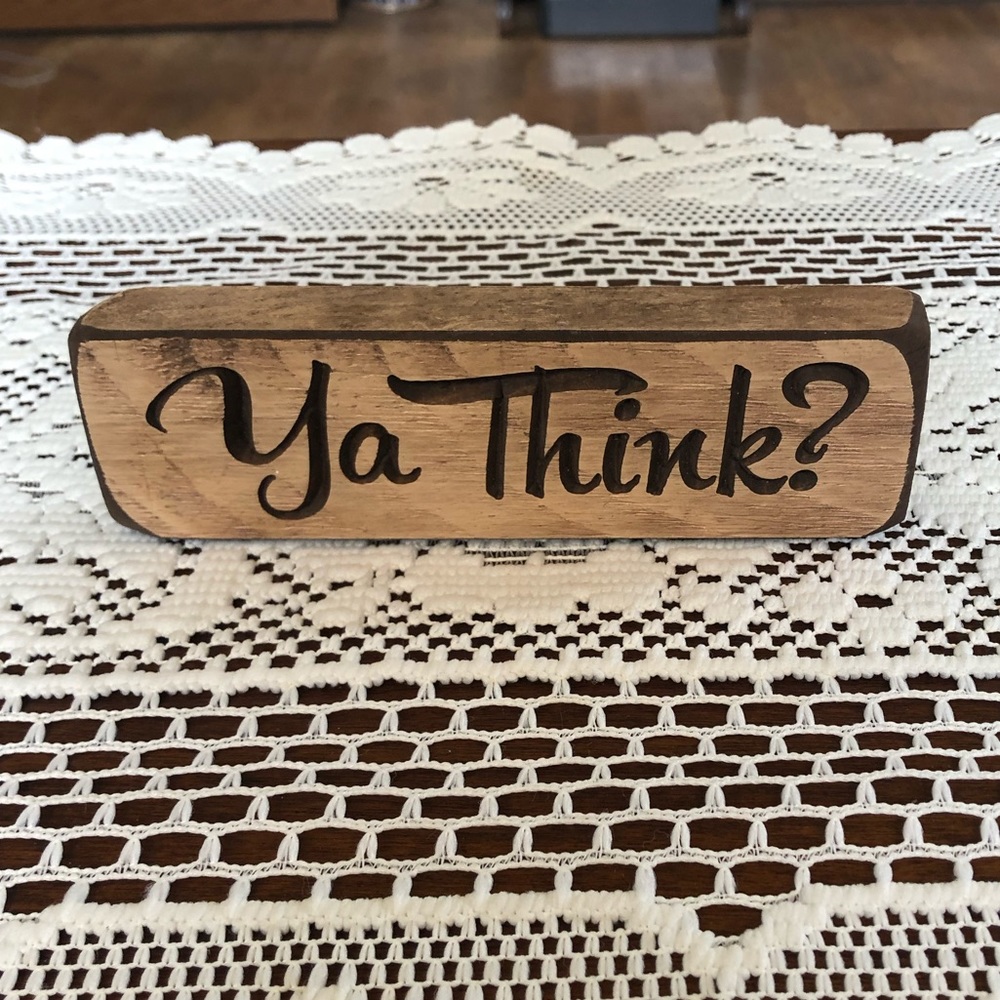 Sarcastic wooden sign “YA THINK”